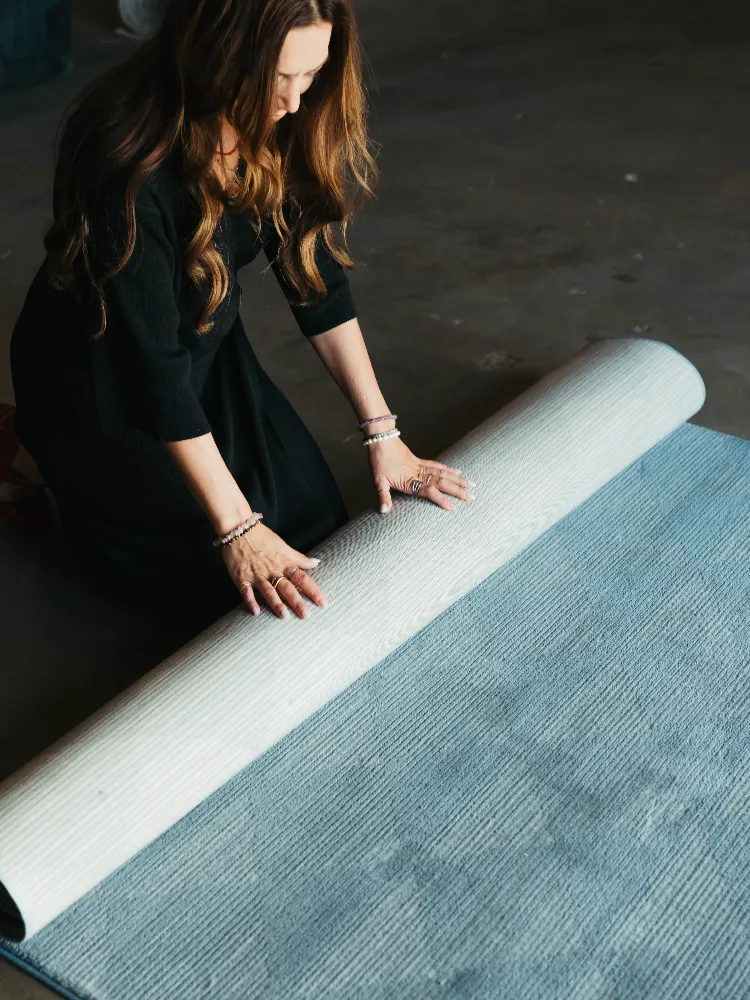 rolling out a blue area rug in Colorado 